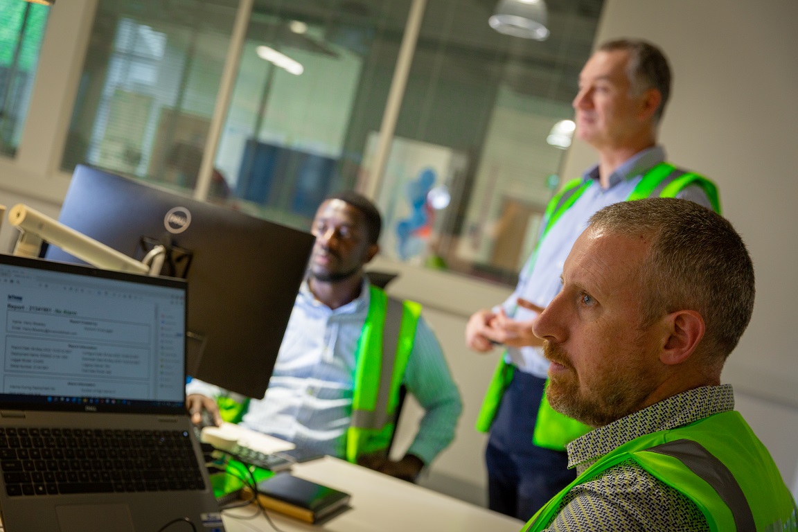 Team sat around laptop displaying cold chain partnerships